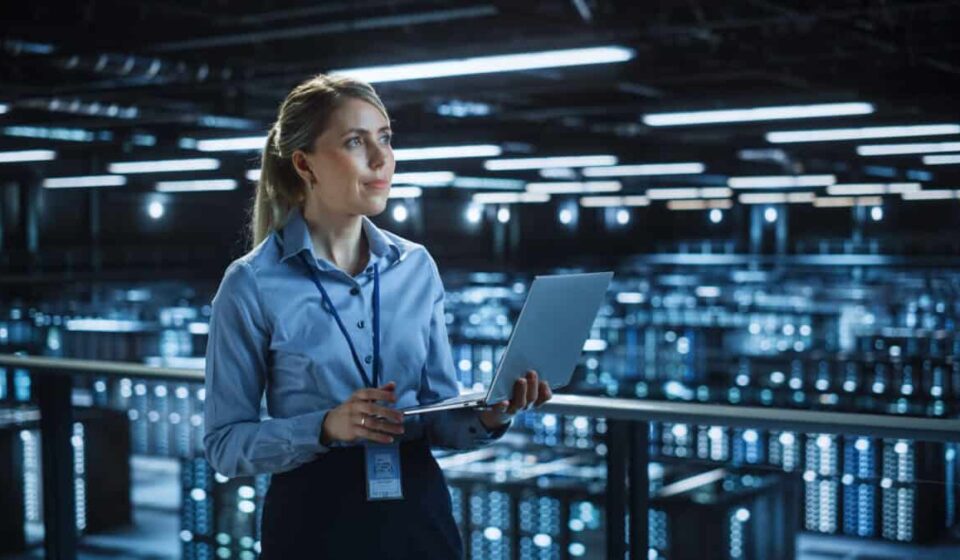 Data center woman holding laptop