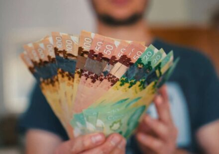Person holds banknotes of Canadian dollars
