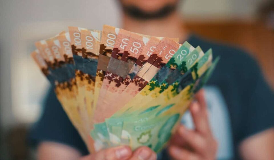 Person holds banknotes of Canadian dollars