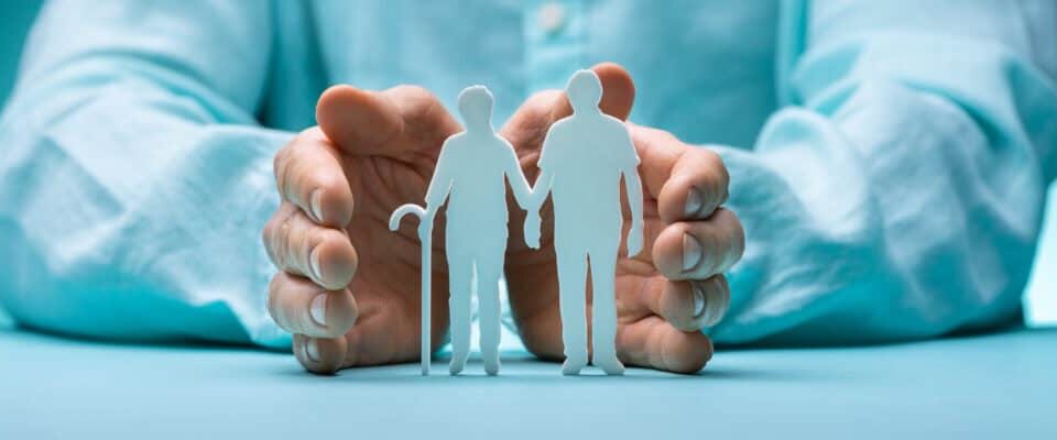 Hand Protecting Senior Couple