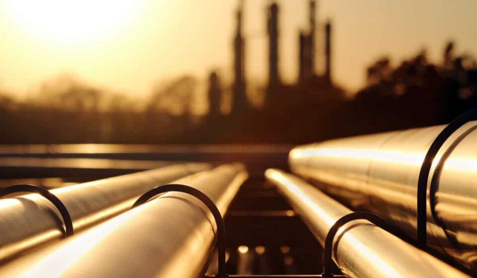 golden sunset in crude oil refinery with pipeline system