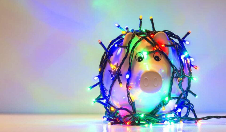 Piggy bank wrapped in Christmas string lights